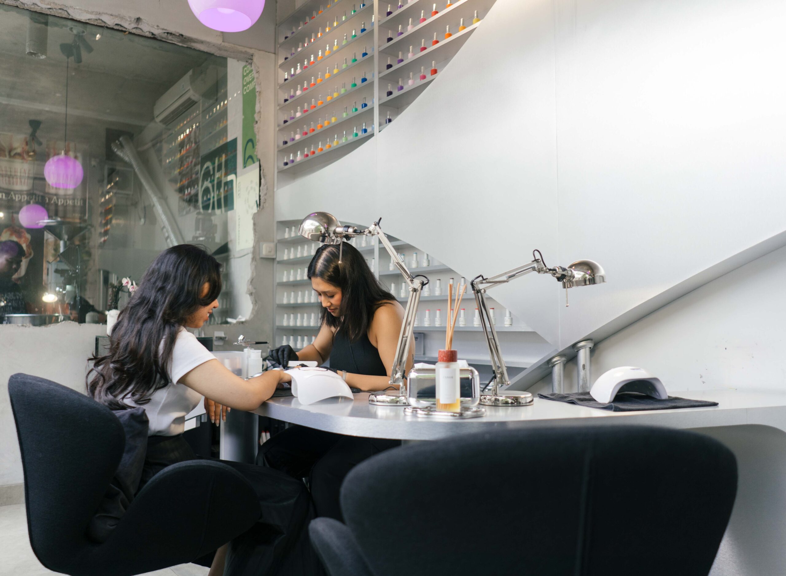 Nail artist creating detailed nail art in a professional studio